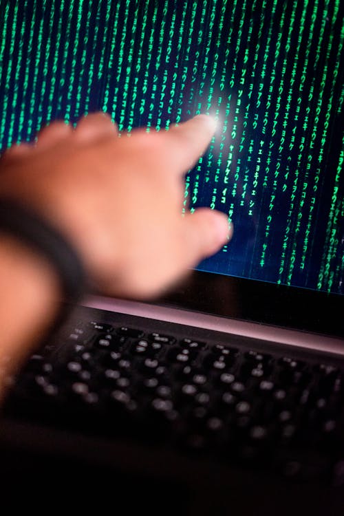 Hand Pointing at Computer Screen · Free Stock Photo