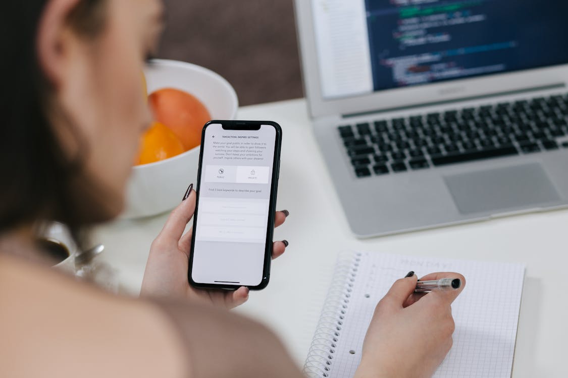 Women Holding Space Gray Iphone X and Black Pen