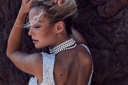 Woman in Backless Wearing Pearl Necklace 