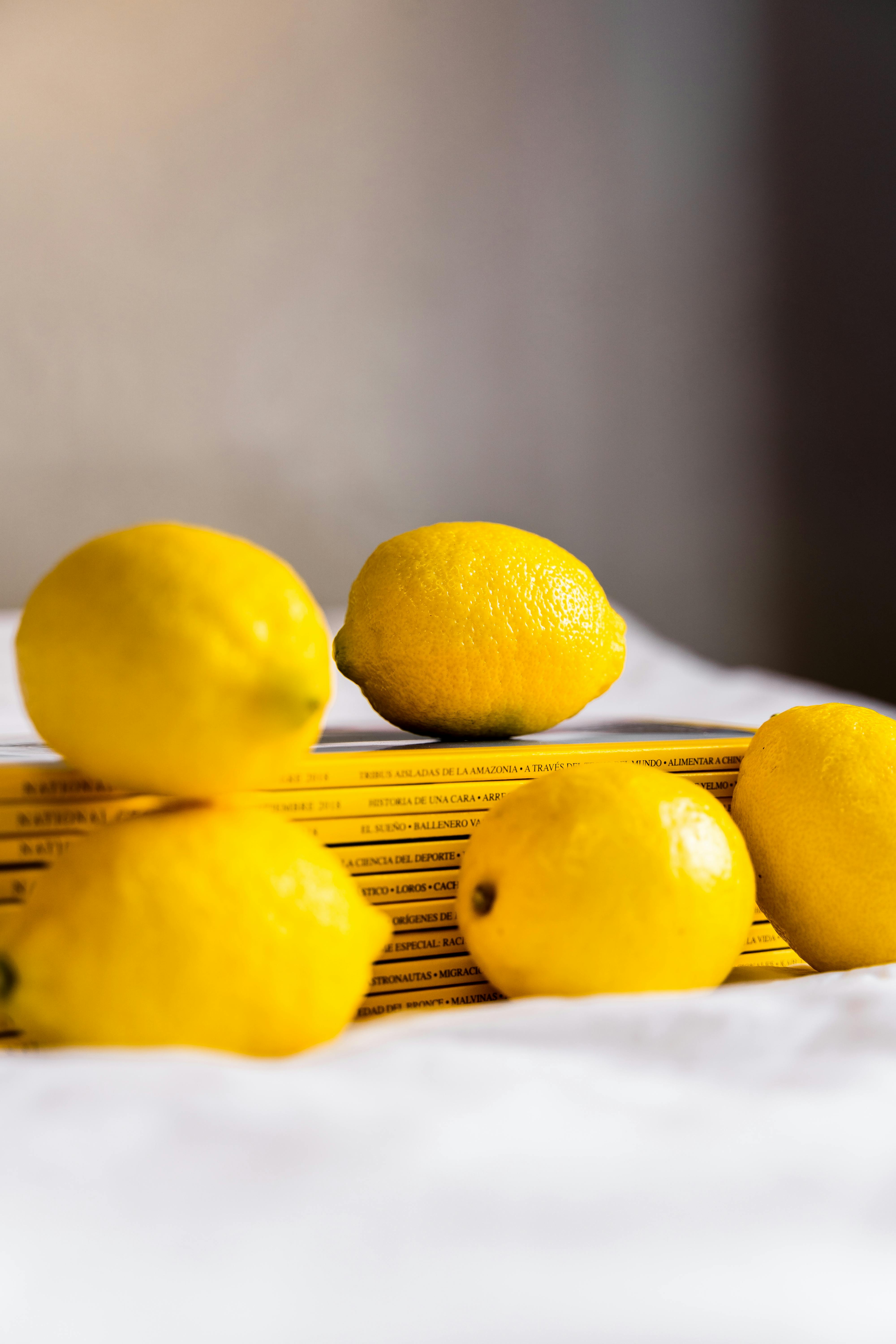 heap of fresh whole lemons scattered on table