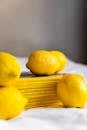 Lemons scattered on table near stack of magazines