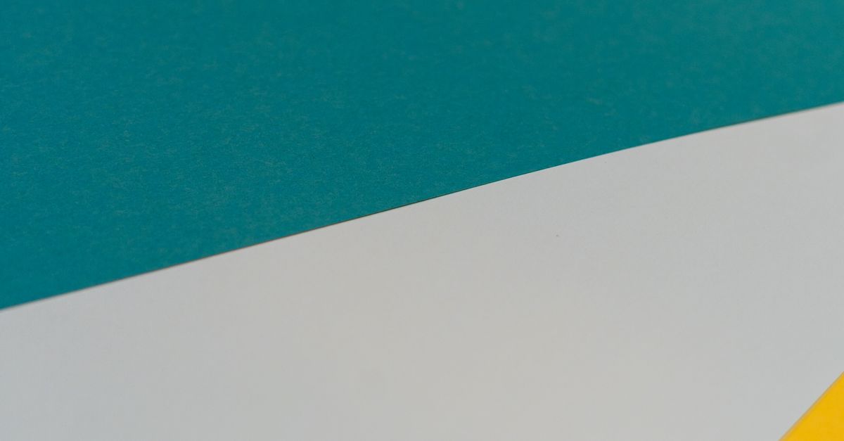 From above of bright multicolored paper with triangle shaped figures as abstract background