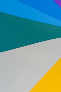 From above of bright multicolored paper with triangle shaped figures as abstract background