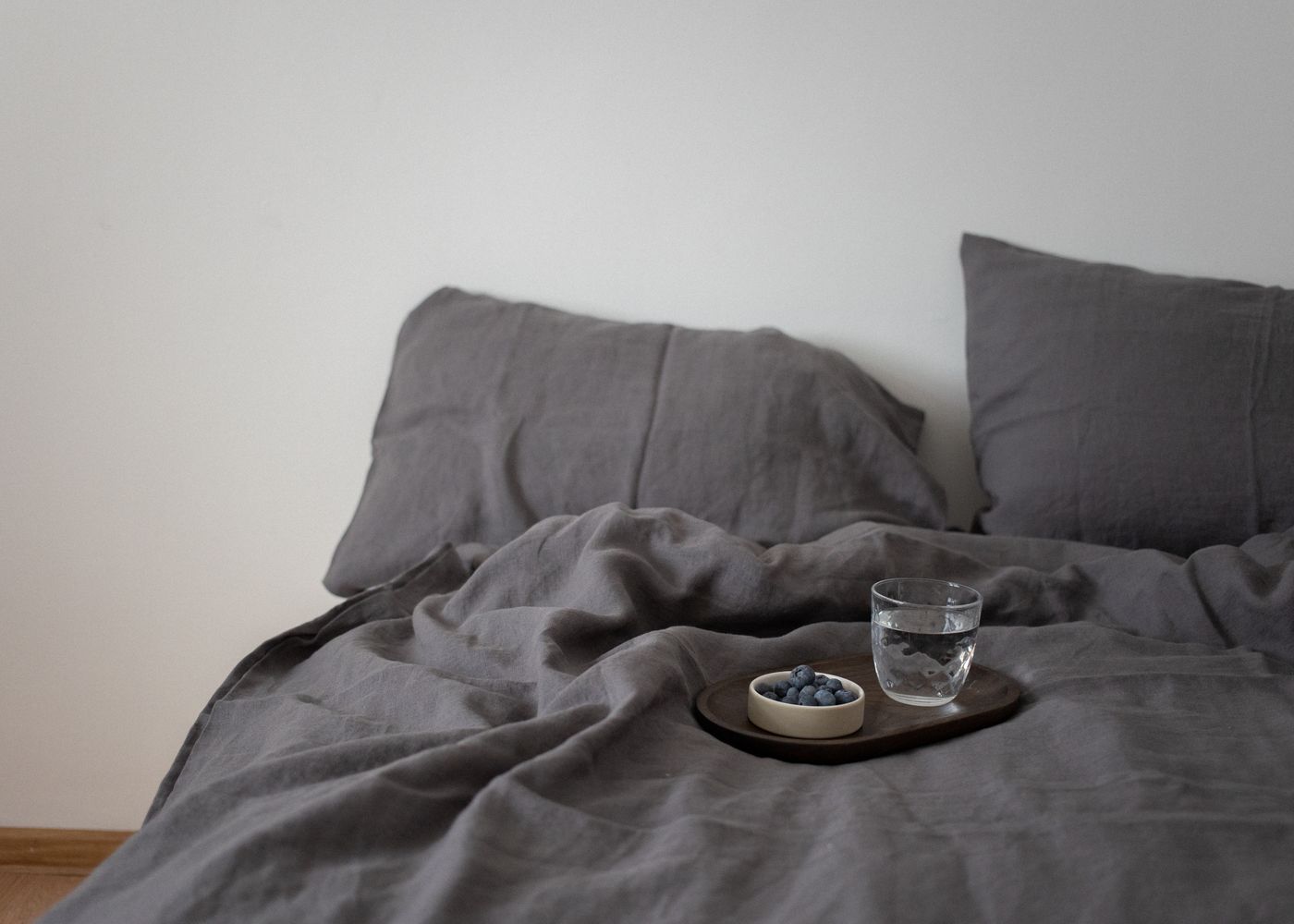 Calm bedroom with grey linen bedding
