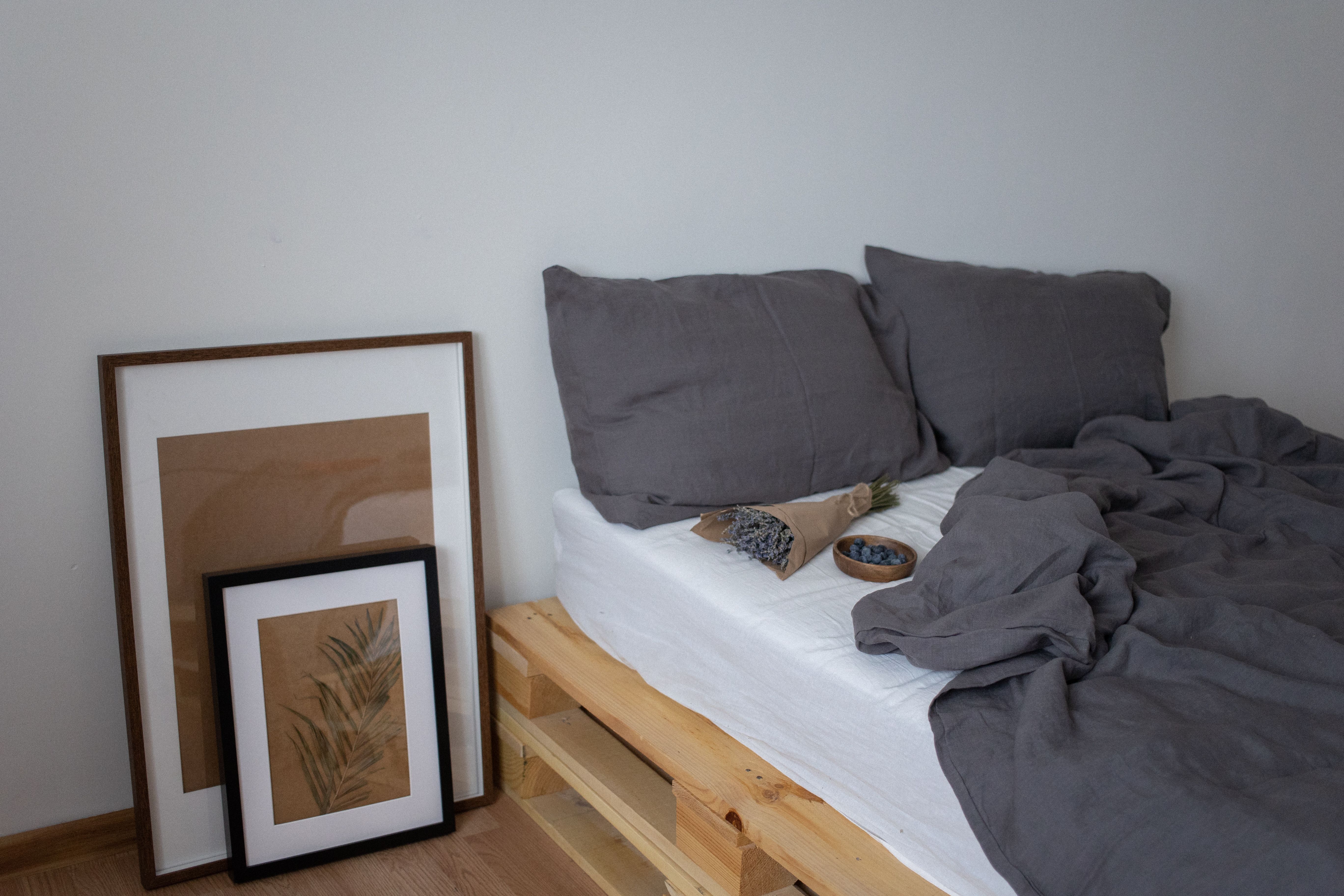 Neatly folded white bed linen on a shelf