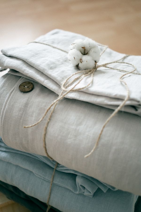 Folded linen tied with twine — photo by Katrin Bolovtsova on Pexels
