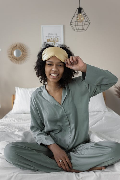 Free A Woman Sitting on the Bed Stock Photo