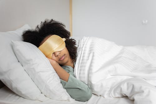 Free A Woman Lying on the Bed Stock Photo