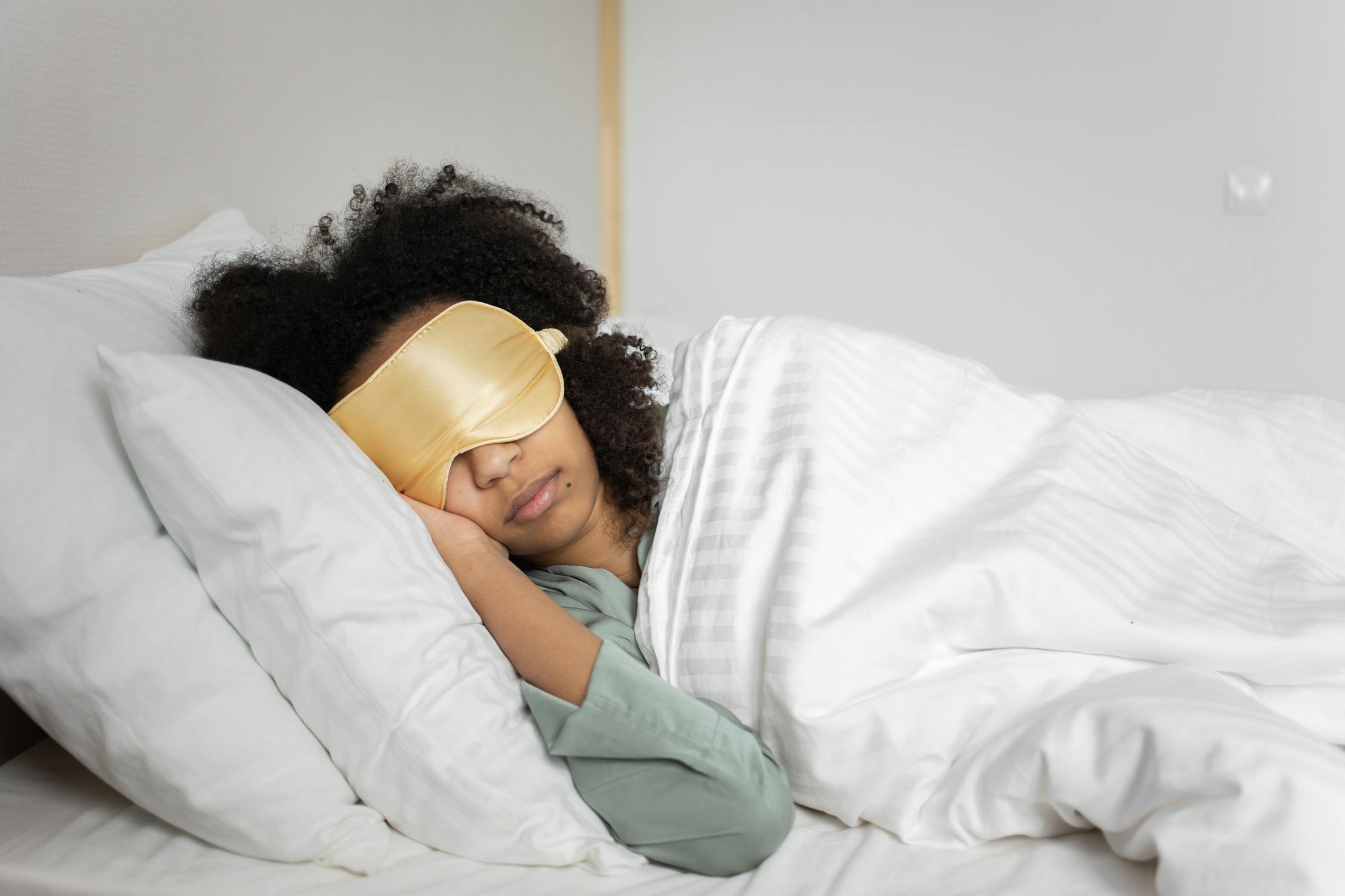black woman sleeping with eye mask. know how your roommates sleep to enjoy your group trip.