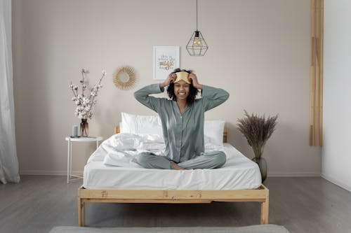 Free A Woman Sitting on the Bed Stock Photo