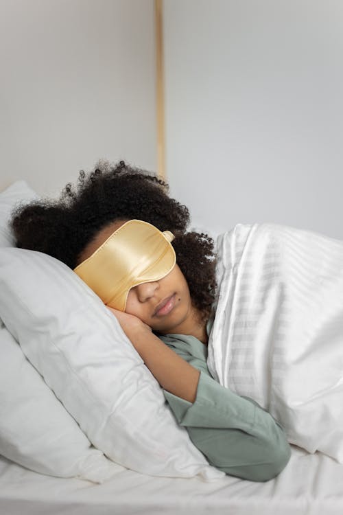 Free A Woman Sleeping on the Bed Stock Photo