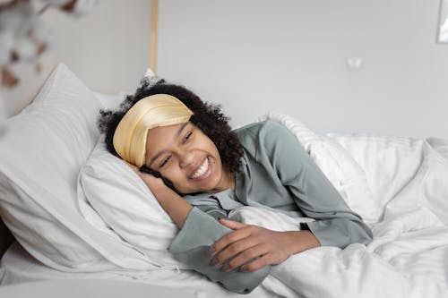 Free A Woman Lying on the Bed Stock Photo