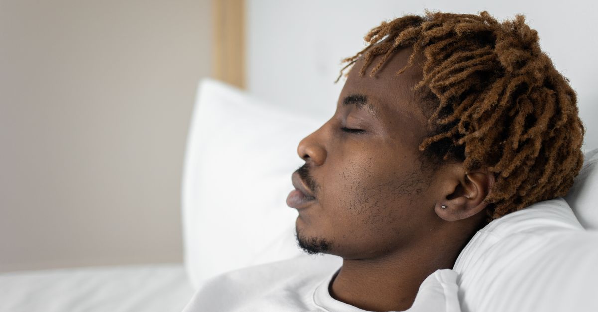 Close-up of a young man sleeping in bed, capturing a serene moment of rest and relaxation. - Evidence evidence guide for rooibos sleep randomized trial