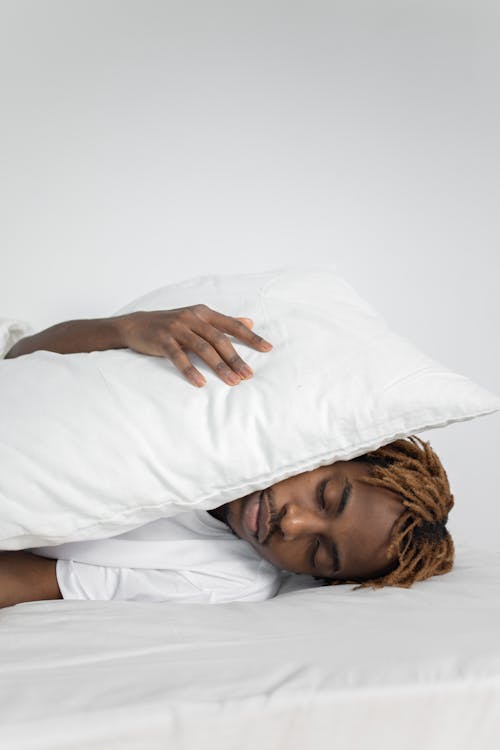 Free Man Holding White Pillow While Sleeping Stock Photo