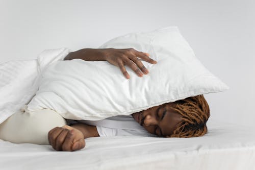 Man Sleeping With Pillow on His Head 