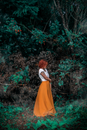 A Woman Standing on Green Grass Field