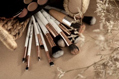 Makeup brushes on a beige surface by Karen Laark Boshoff on Pexels