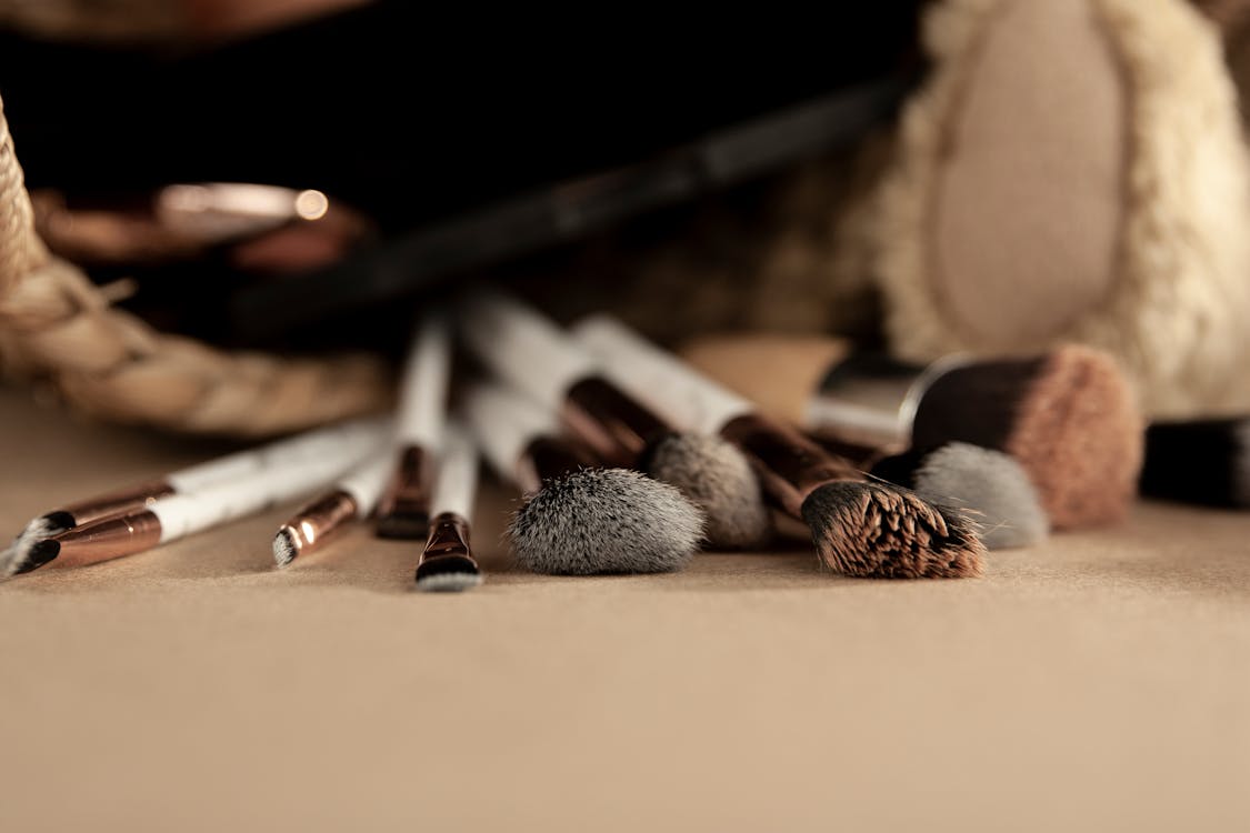 Set of professional makeup brushes on table