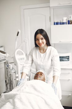 Beautician performing a relaxing spa treatment on client in a modern beauty salon.