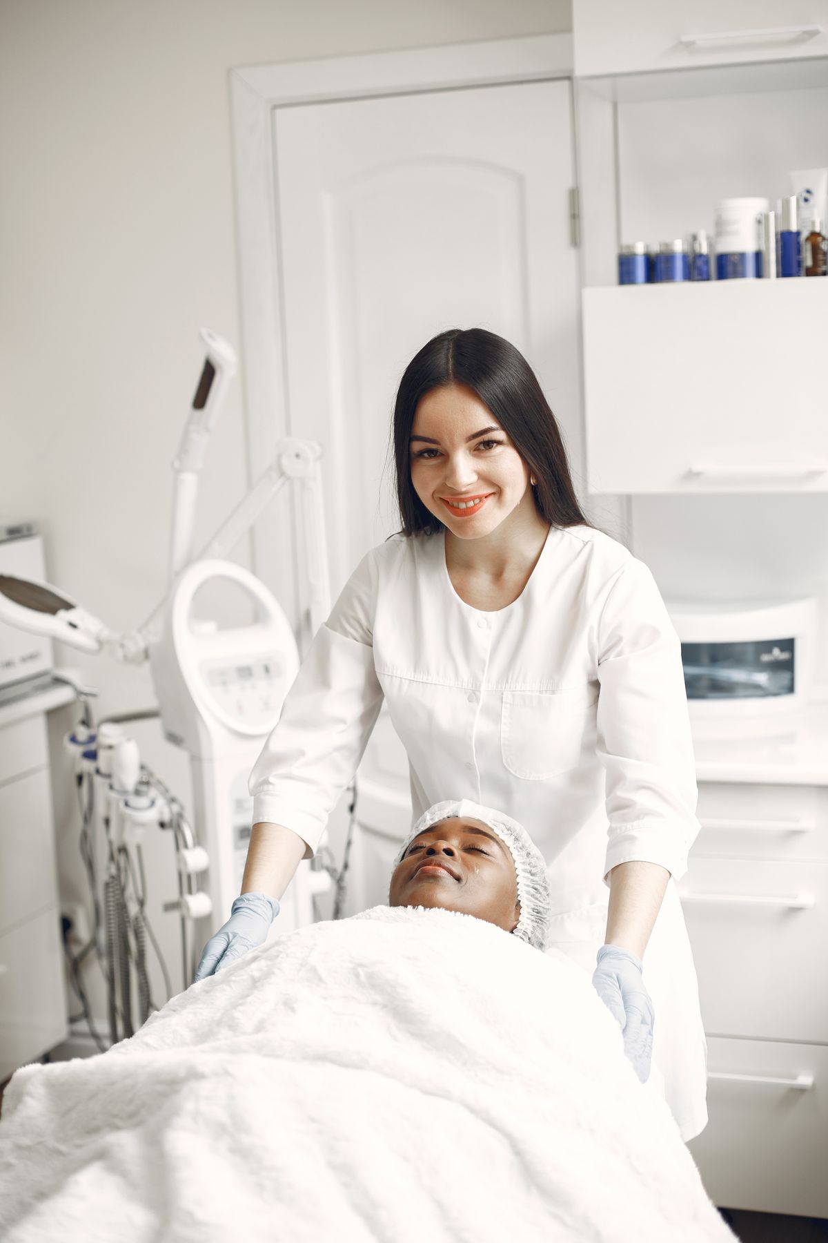 A beautician performing a relaxing treatment for a client in a modern salon