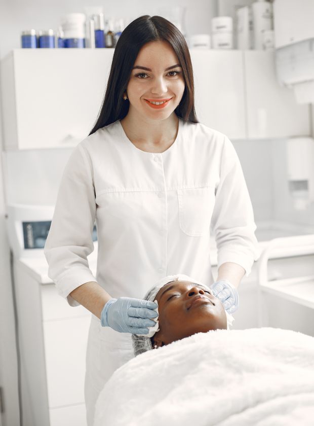 Female skincare professional giving a facial treatment