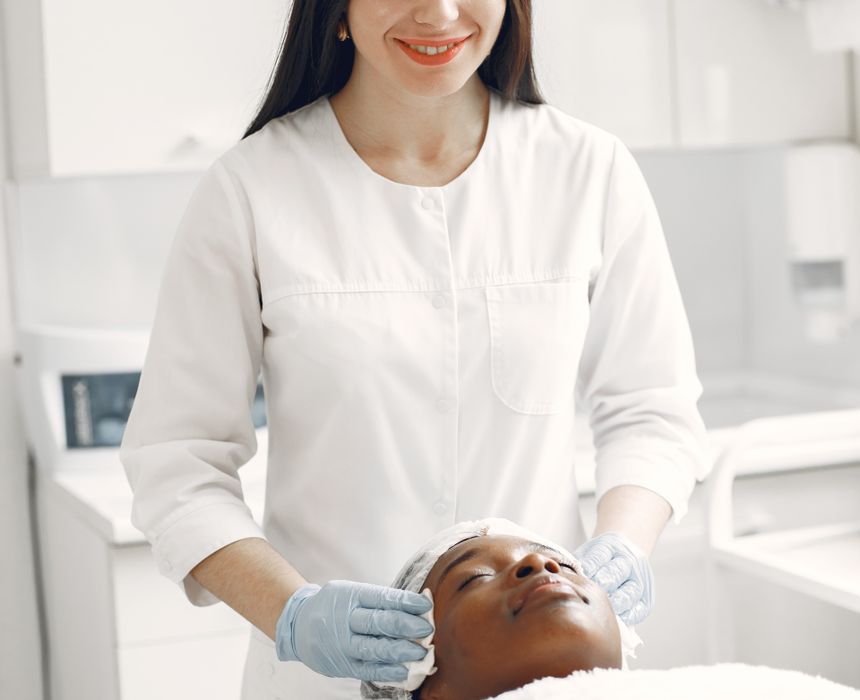 Female skincare professional giving a facial treatment