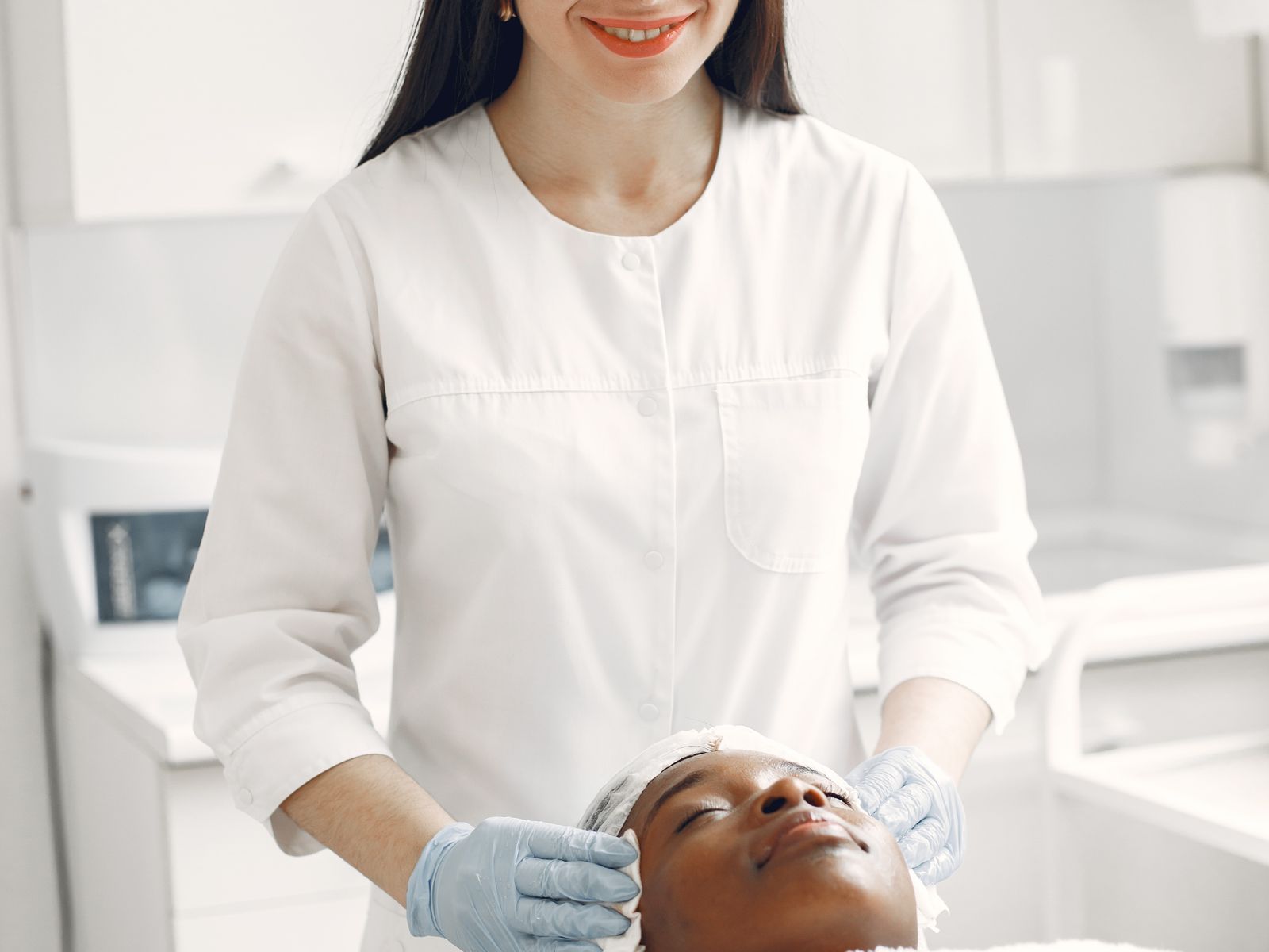 Aesthetic clinician with a relaxed client during a skincare visit