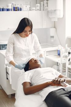 Woman receiving relaxing facial treatment at a modern spa.