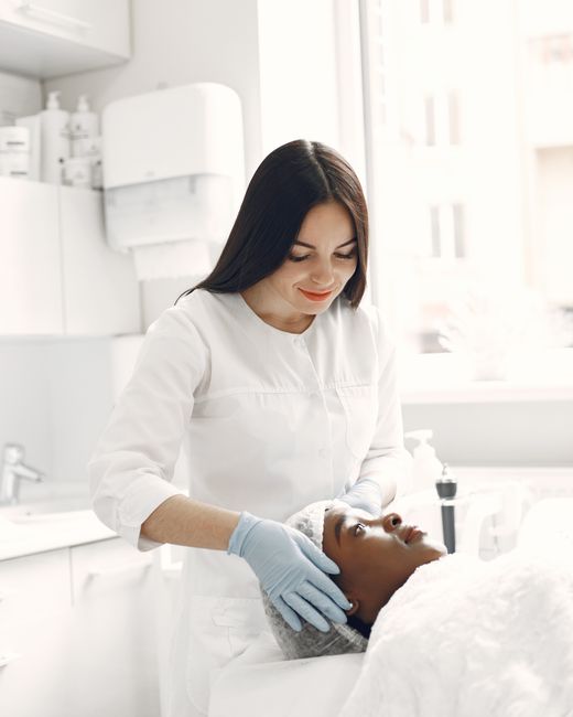 Beautician carrying out a facial for a relaxed client
