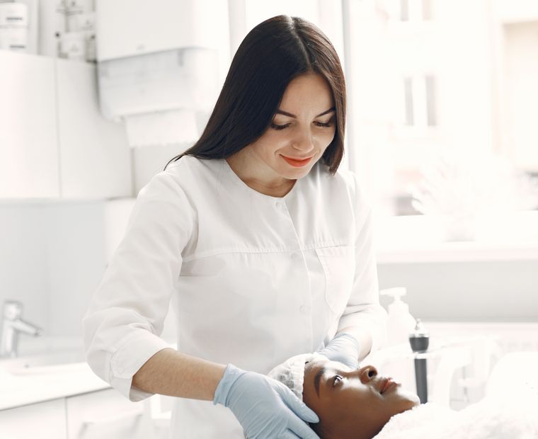 Beautician carrying out a facial for a relaxed client