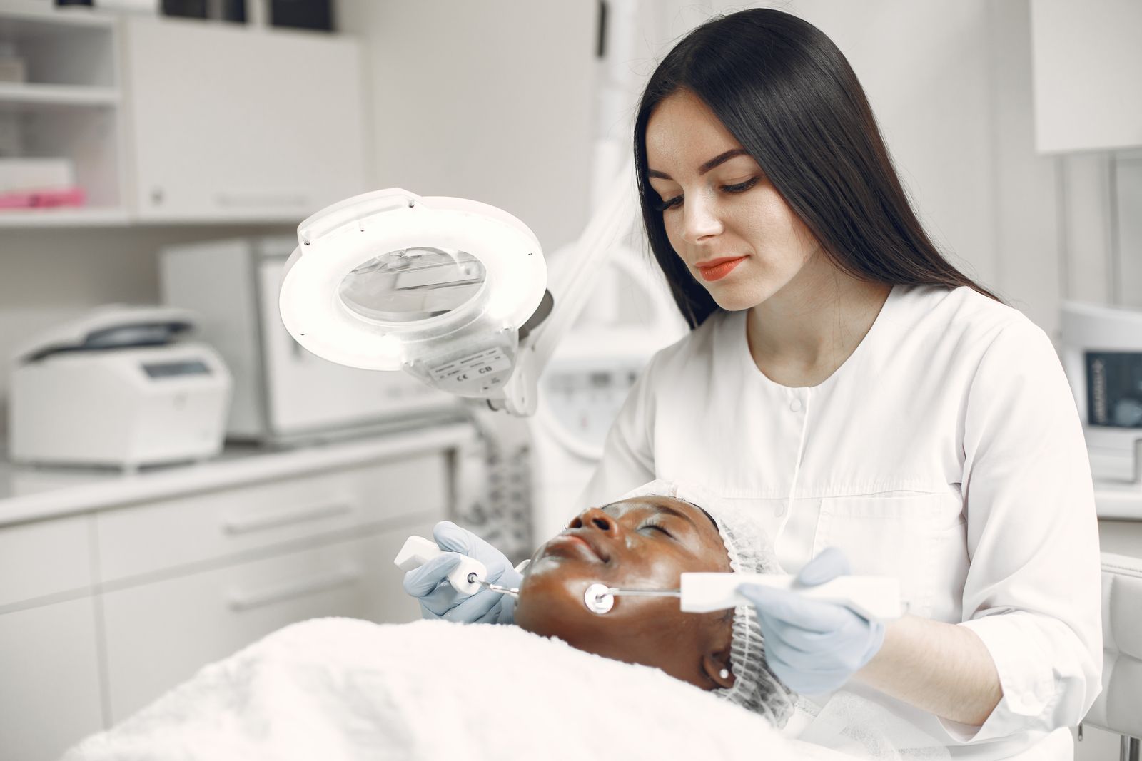 Dermatology professional providing a skin treatment to a patient
