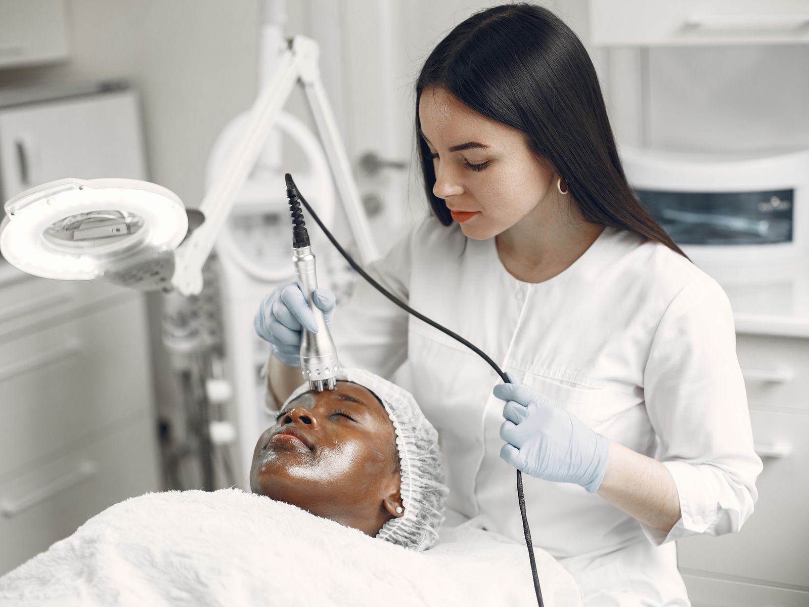 Skin specialist caring for a client in a modern clinic