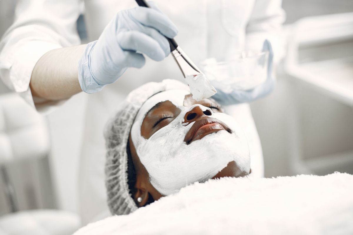 A client receiving a calming facial mask in a professional spa