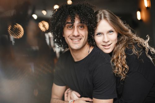Free A joyful couple embracing and smiling, capturing warmth and love. Stock Photo