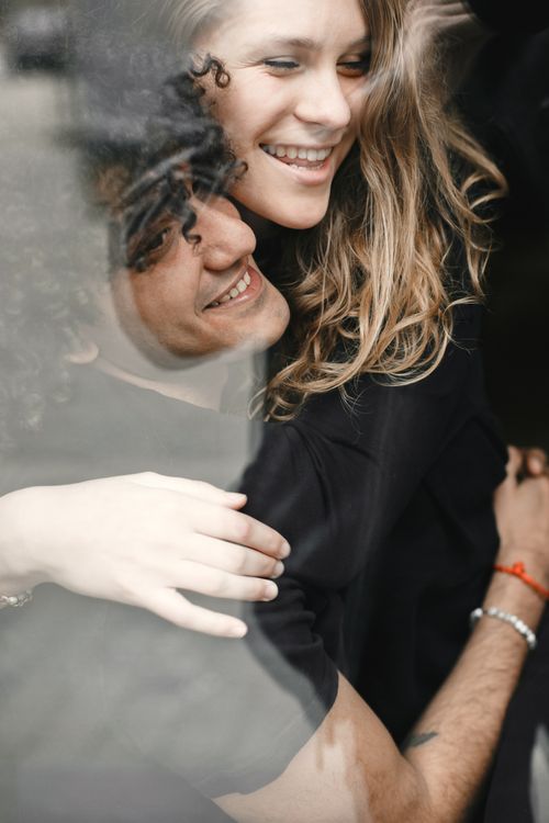 Free A joyful couple embracing, exuding love and happiness in an intimate indoor setting. Stock Photo