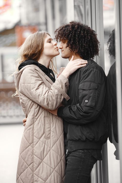 Free Couple sharing an intimate moment outdoors dressed warmly on a chilly day. Stock Photo