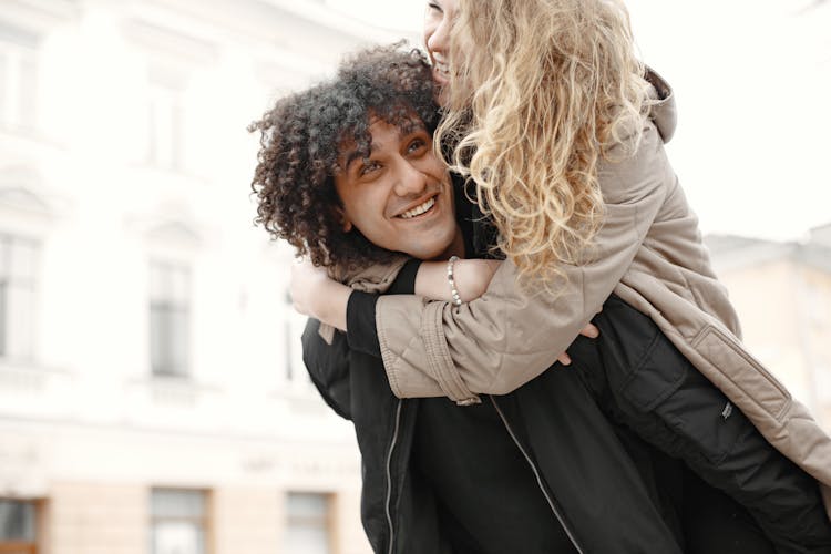 Man Carrying His Girlfriend On His Back 