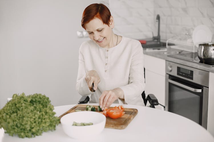 Woman Slicing A Vegetable