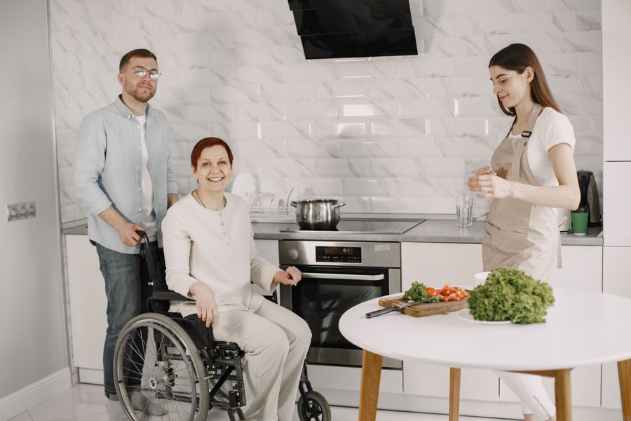 Caregiver talking with a senior woman in her living room