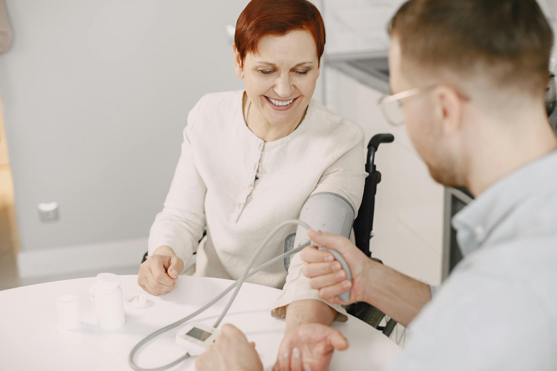 A Man Checking the Elderly Woman's Blood Pressure using Sphygmomanometer