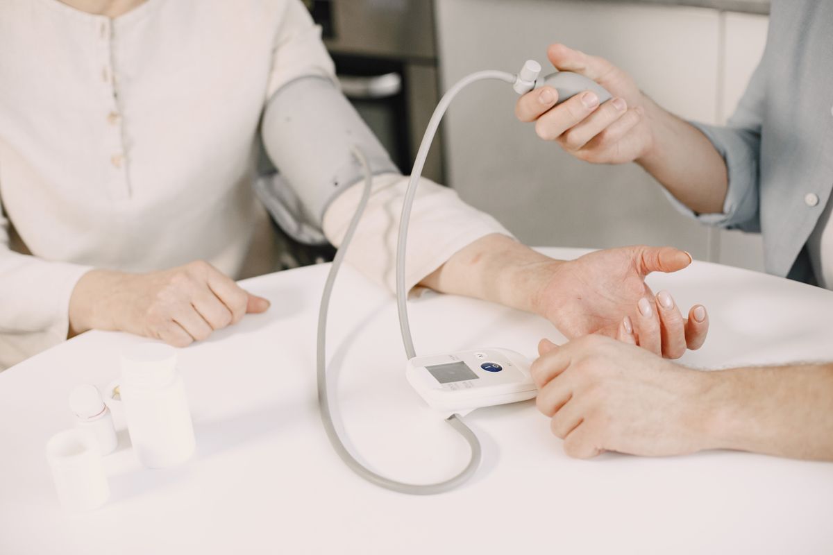 Someone checking their blood pressure at a table