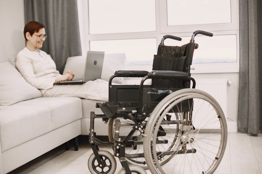 Hospice volunteer sitting and talking with an elderly patient