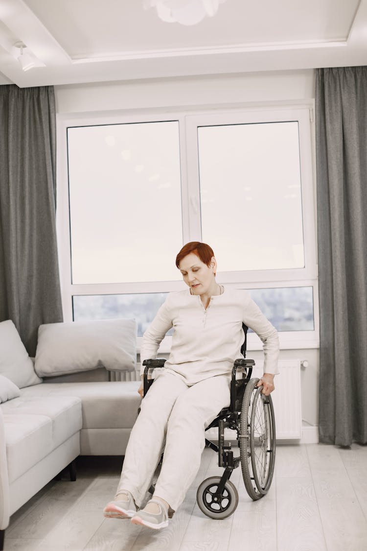 Elderly Woman On A Wheelchair At Home 