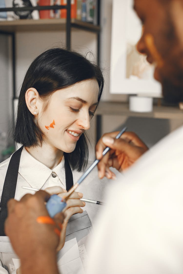 Putting Paint On A Woman's Face