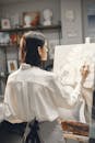 Back View of a Woman Painting on Canvas