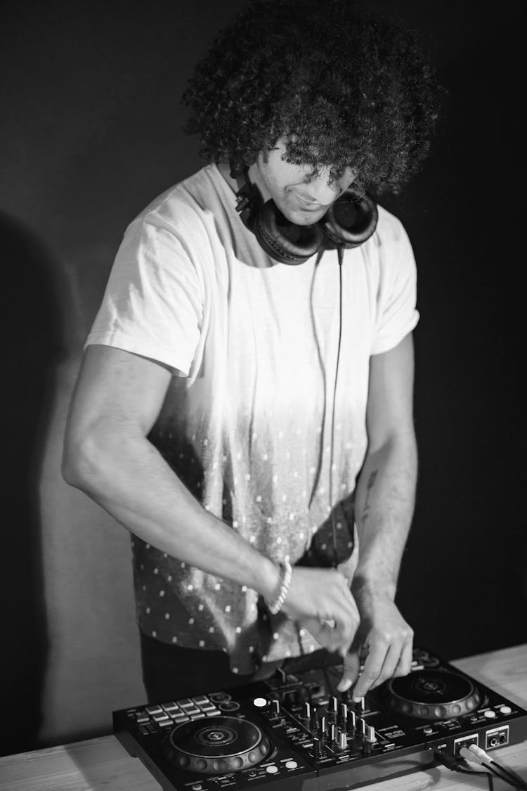 Man In White T-Shirt Playing On DJ Mixer