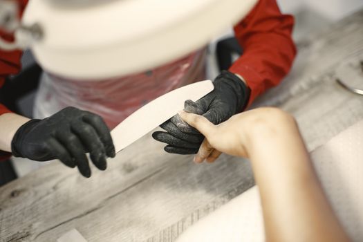 Woman in Black Latex Gloves Doing Manicure