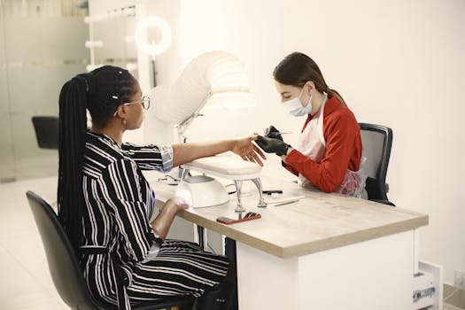 A manicurist provides a professional nail treatment to a client in a modern salon setting.
