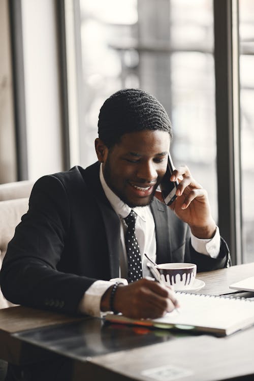 Businessman on a Phone Call Sitting in a Cafe 