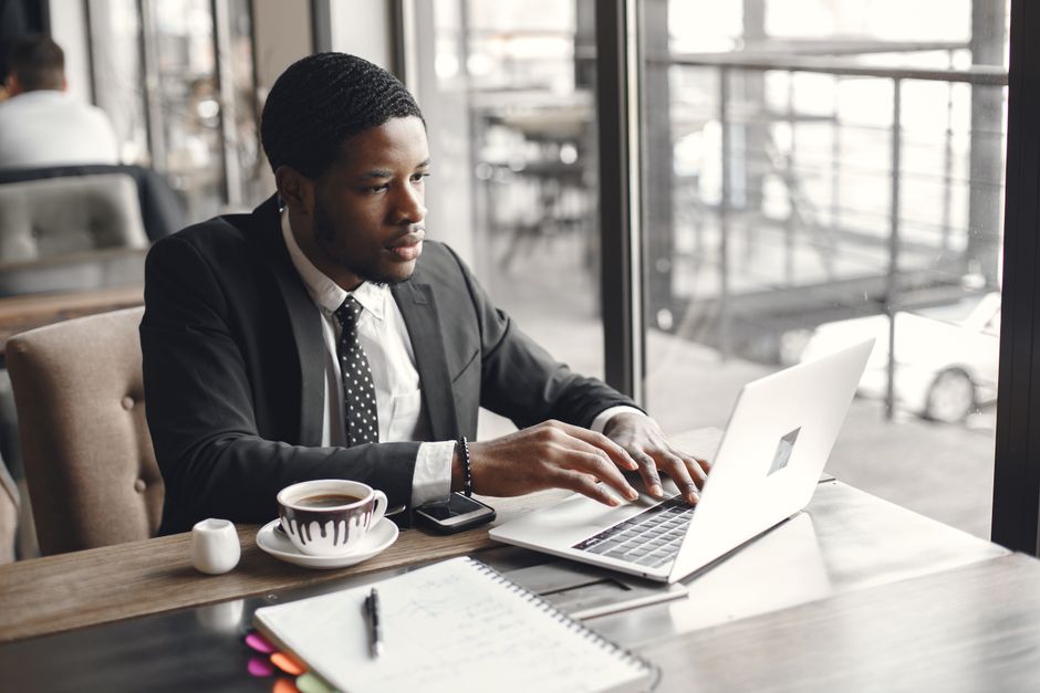 professional using a laptop in a transit lounge - corporate travel insurance australia professional using a laptop in a transit lounge - corporate travel insurance australia